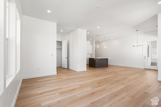 549 North Legend Circle, Unit C/466 Mapleton, UT 84664 - Photo 10 of 39 Unfurnished living room with a chandelier, light wood-style floors, and recessed lighting