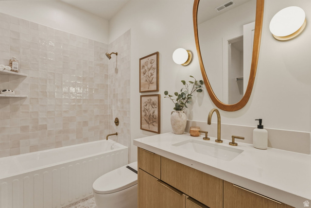923 North Emery Lane Elk Ridge, UT 84651 - Photo 64 of 101 Bathroom featuring a vanity with wood-finish cabinetry, a white countertop, and a vessel sink with brass fixtures