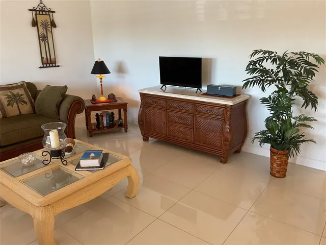a living room with furniture and a lamp
