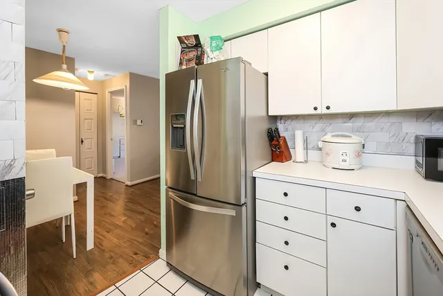 a kitchen with stainless steel appliances a refrigerator and a stove