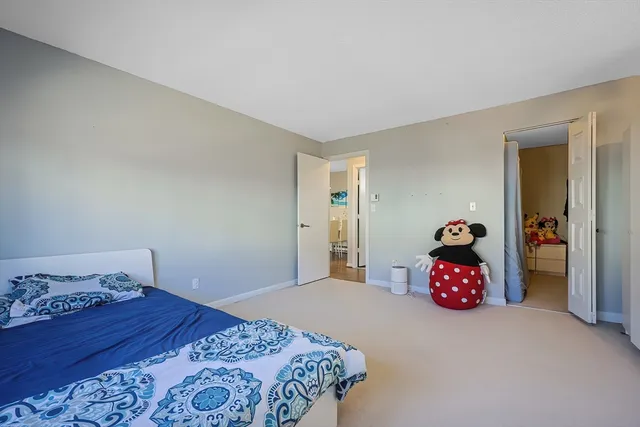 a bedroom with a bed and cabinets