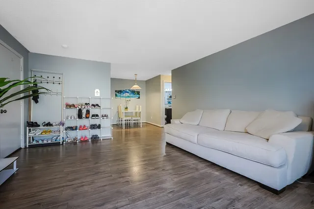 a living room with furniture and a table with wooden floor