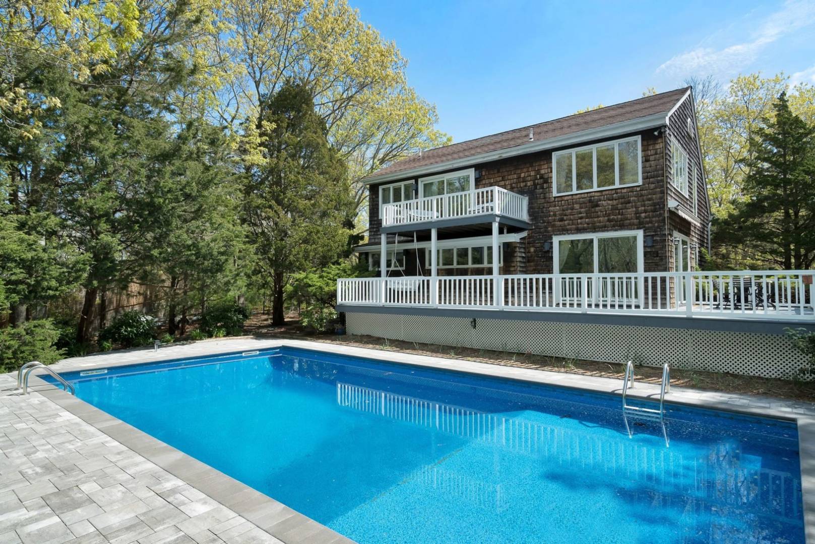3 Crows Nest Circle Southampton, NY 11968 - Photo 1 of 18 a view of a swimming pool with an outdoor seating