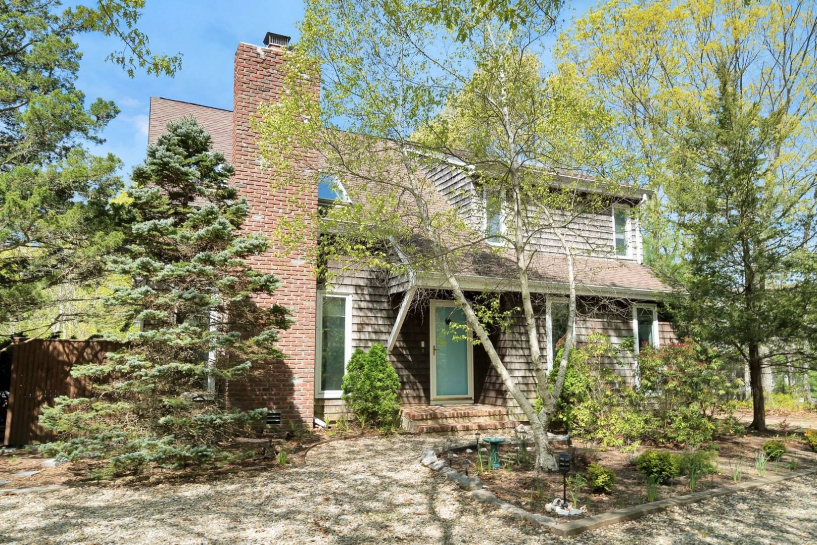 3 Crows Nest Circle Southampton, NY 11968 - Photo 2 of 18 a front view of a house with garden
