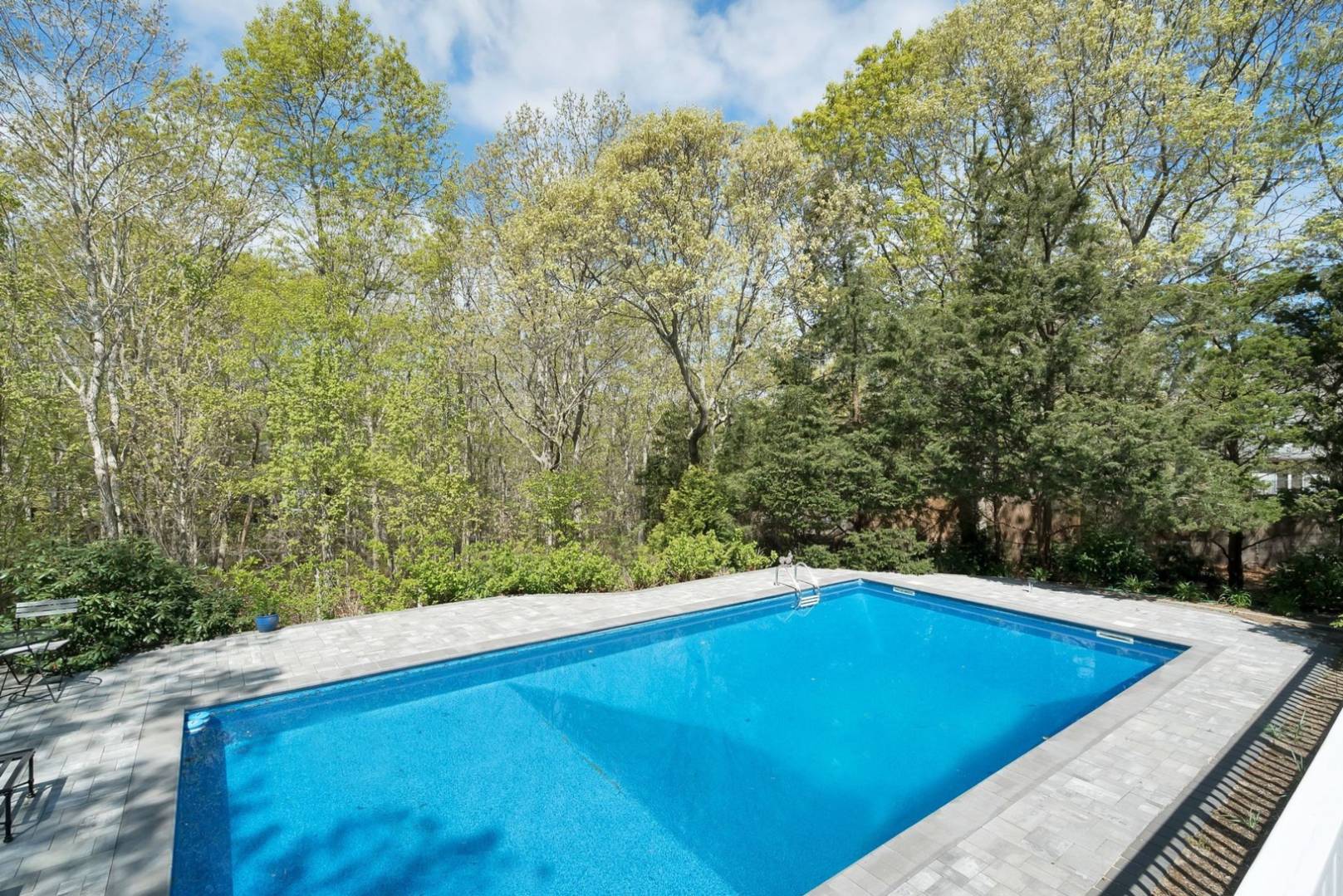 3 Crows Nest Circle Southampton, NY 11968 - Photo 13 of 18 a view of a pool with a yard