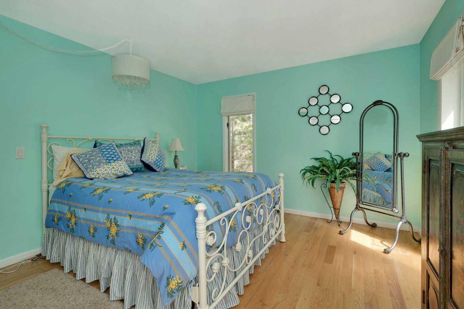 3 Crows Nest Circle Southampton, NY 11968 - Photo 10 of 18 a bedroom with a bed table and a chandelier
