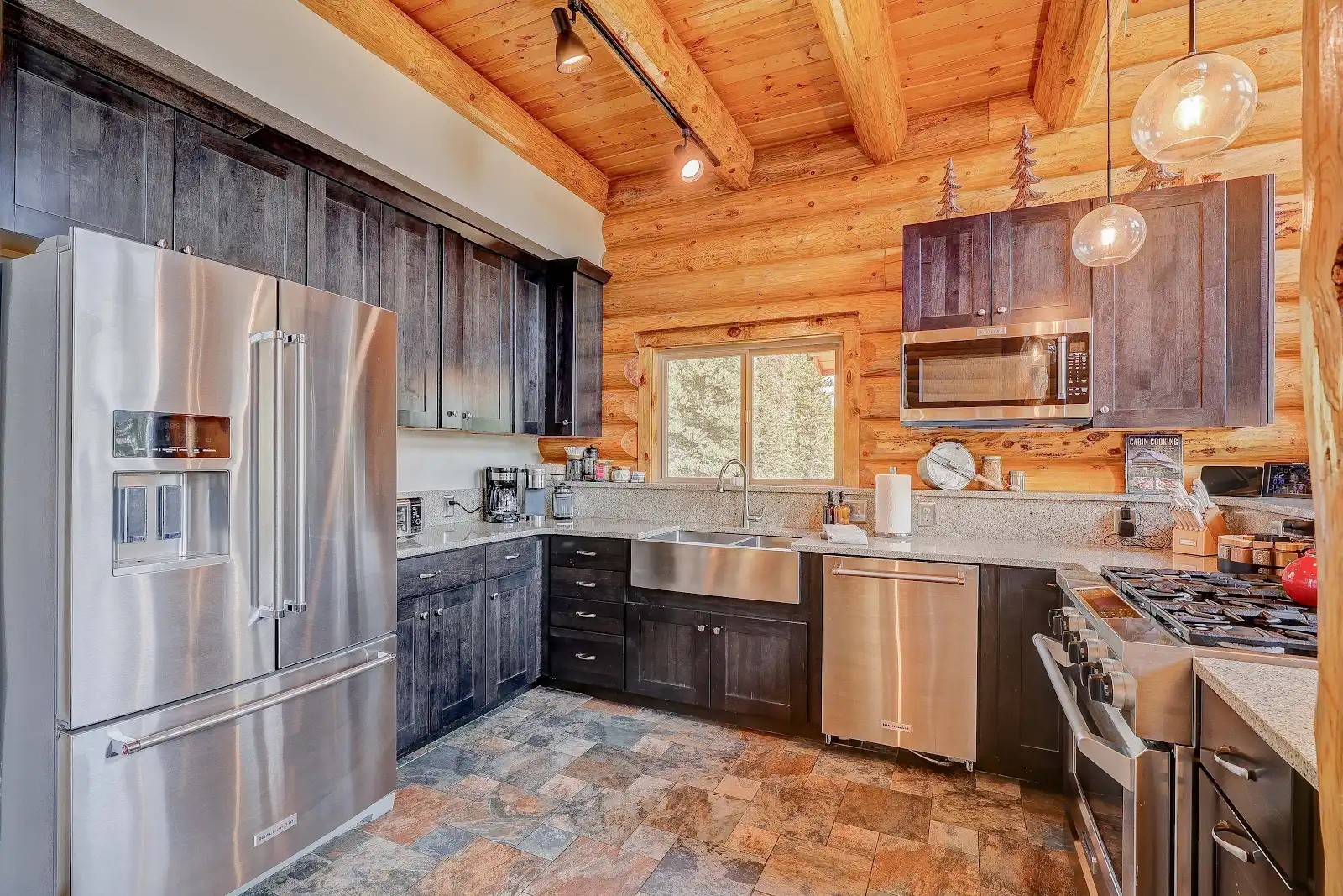 395 Miners Way Fairplay, CO 80440 - Photo 7 of 43 a kitchen with stainless steel appliances granite countertop a refrigerator stove a sink dishwasher and wooden cabinets with a stove