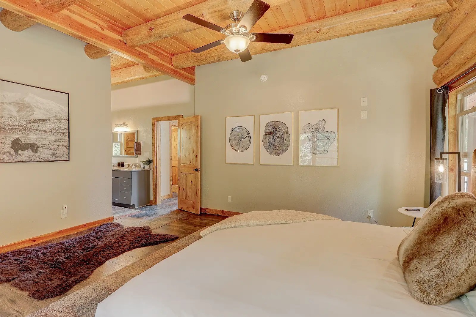 395 Miners Way Fairplay, CO 80440 - Photo 10 of 43 a bedroom with a large bed and a chandelier