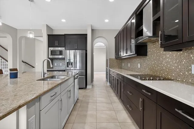 a kitchen with stainless steel appliances granite countertop a refrigerator and a sink