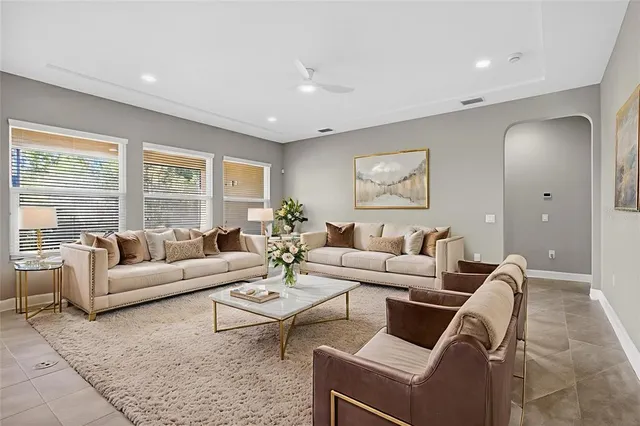 a spacious en suite bathroom with a granite countertop sink and a mirror