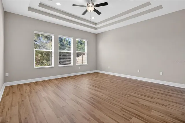 a view of a room with wooden floor and white walls