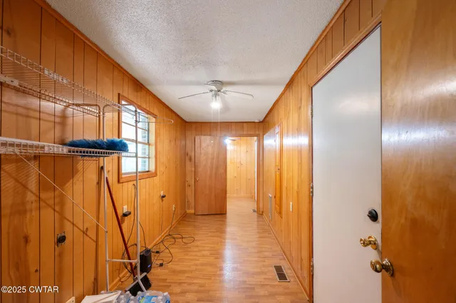 a view of a hallway with a ceiling fan