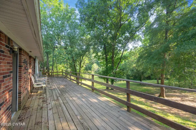 a view of a wooden deck next to a yard