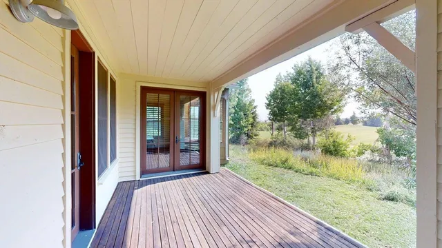 a view of a porch and wooden floor