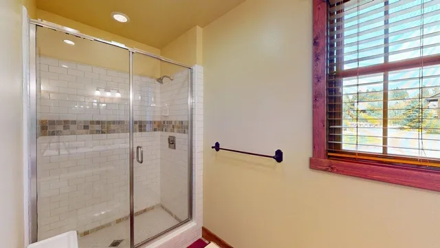 a bathroom with a shower and a sink