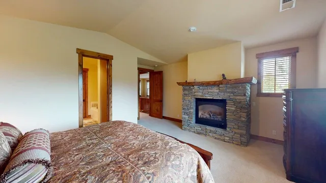 a bedroom with a bed and a fireplace