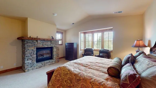 a bedroom with a bed and a fireplace