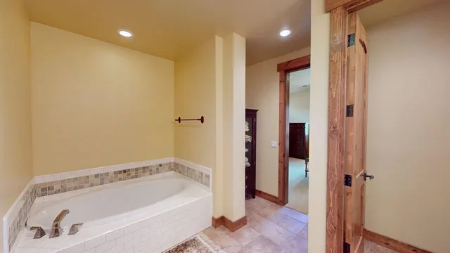 a bathroom with a tub a sink and a shower