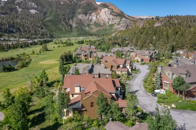 an aerial view of a house with garden space and lake view