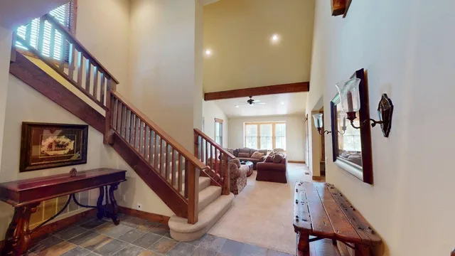 a view of staircase with furniture and a chandelier
