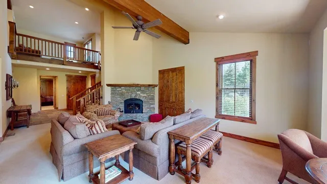 a living room with fireplace furniture and a window