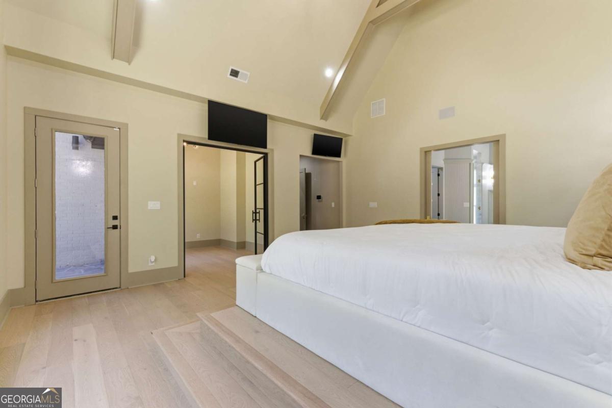 1315 Sandy Creek Road Tyrone, GA 30290 - Photo 67 of 100 a spacious bedroom with a bed and a mirror