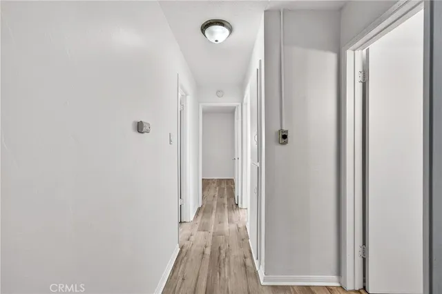 a view of a hallway with wooden floor