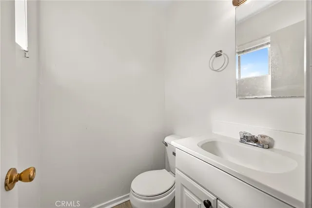 a white toilet sitting next to a white sink