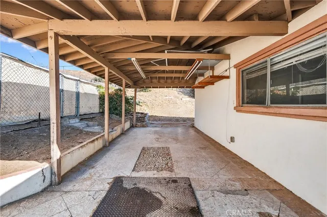 a view of a large room with wooden floor and windows