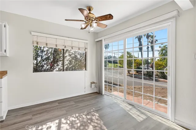 a view of a livingroom with a ceiling fan and window