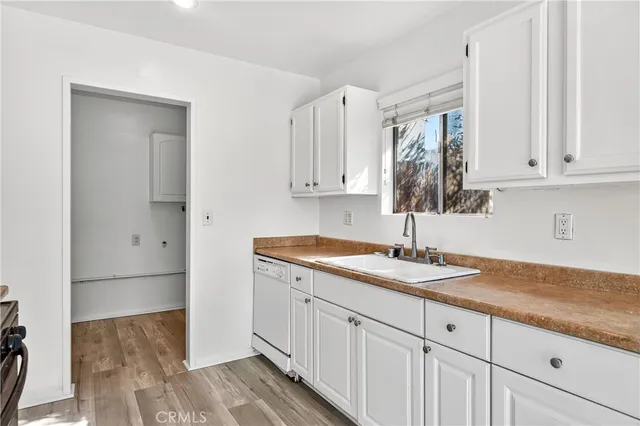 a kitchen with a sink window and cabinets