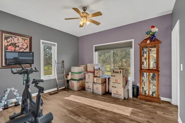 a view of a livingroom with workspace and a window