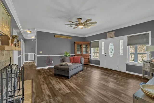 a living room with furniture and wooden floor