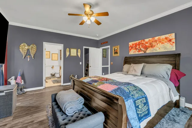 a bedroom with bed and wooden floor