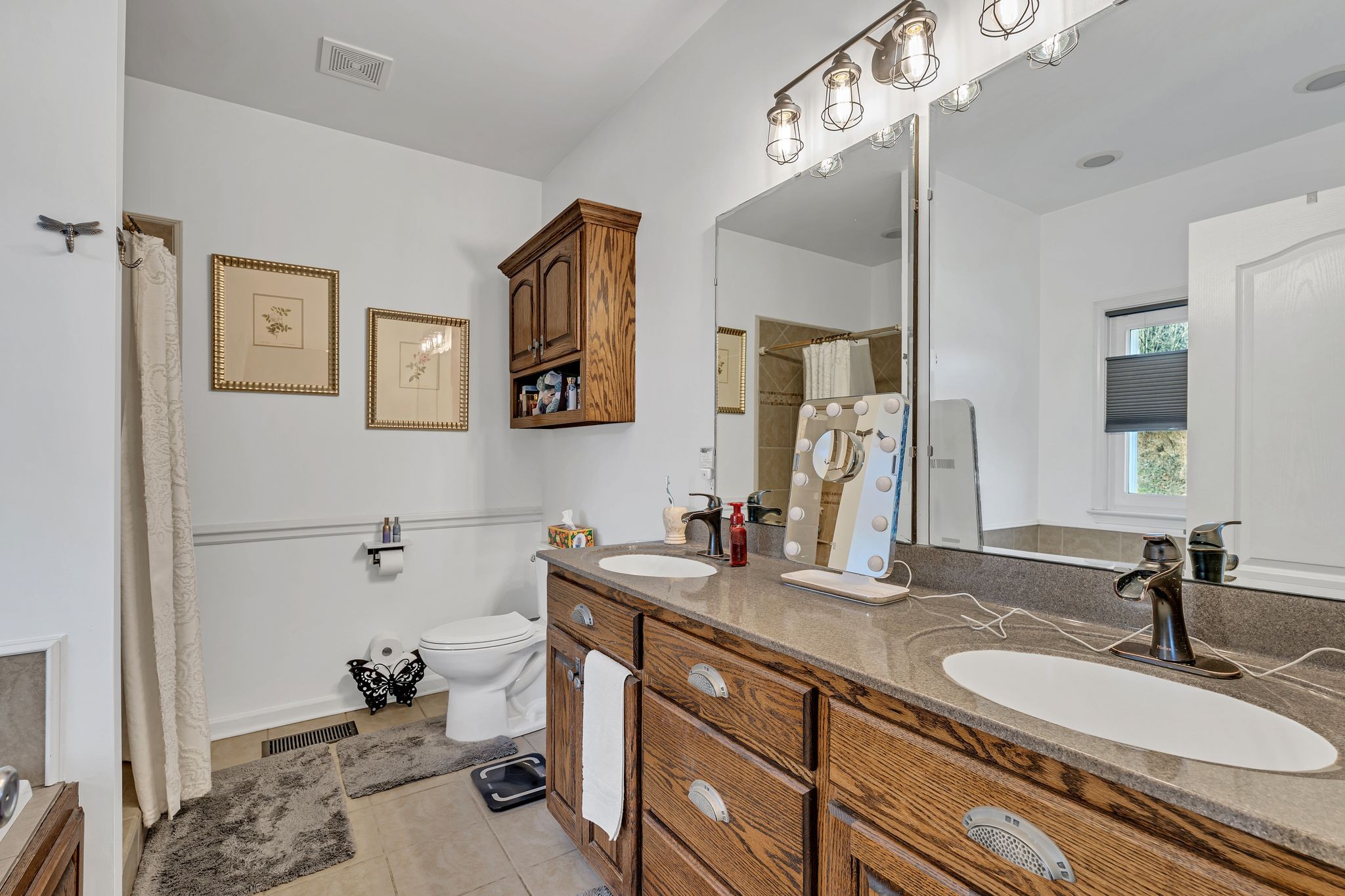 5063 Miller Lake Road Culleoka, TN 38451 - Photo 8 of 22 a bathroom with a sink double vanity and a mirror