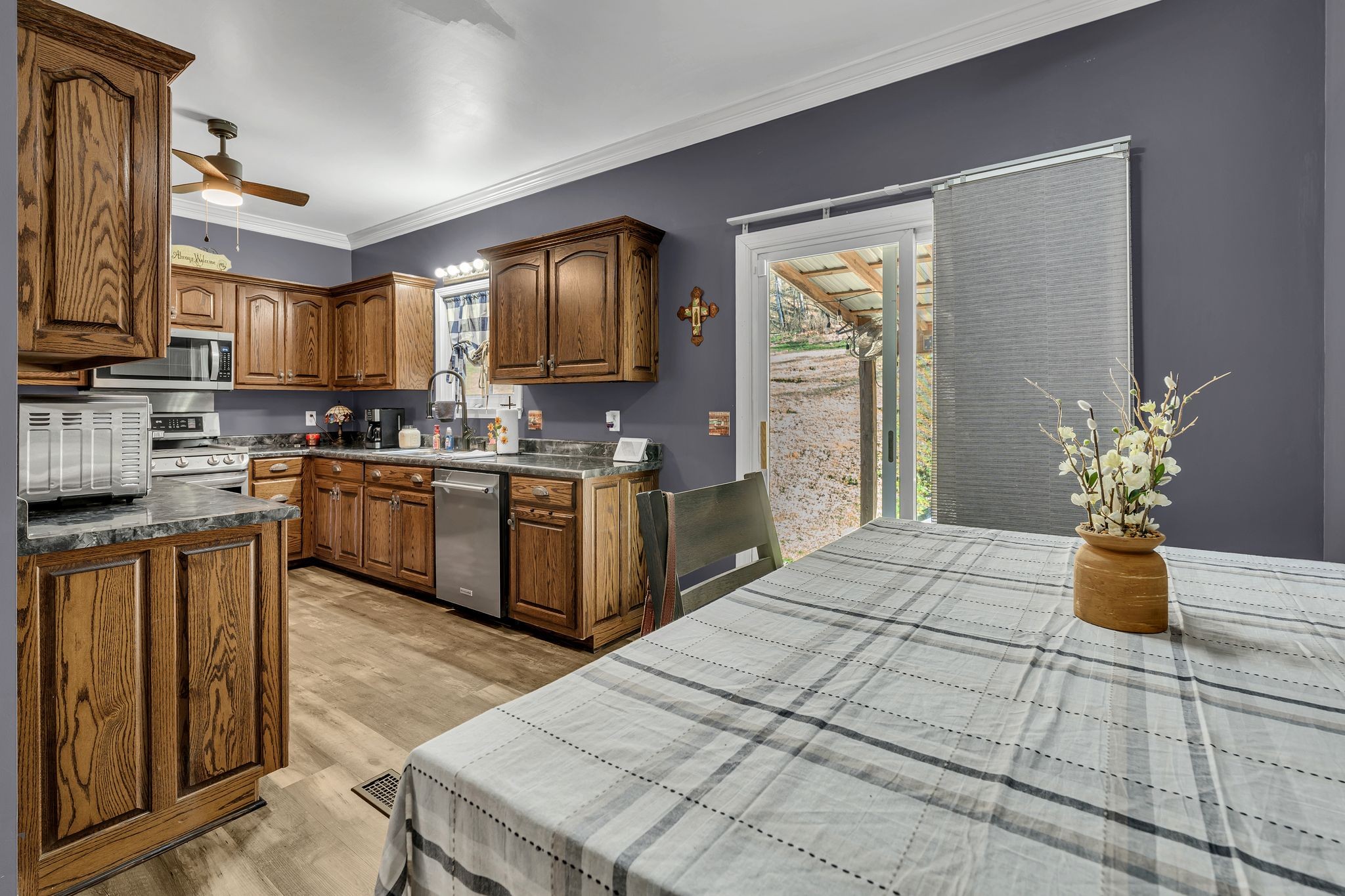 5063 Miller Lake Road Culleoka, TN 38451 - Photo 10 of 22 a kitchen with a sink a stove cabinets and wooden floor