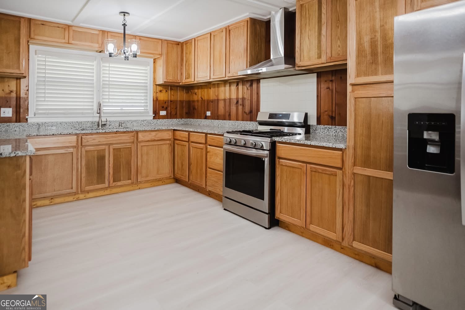 348 School Road Hampton, GA 30228 - Photo 11 of 46 a kitchen with stainless steel appliances granite countertop a stove a sink and a refrigerator