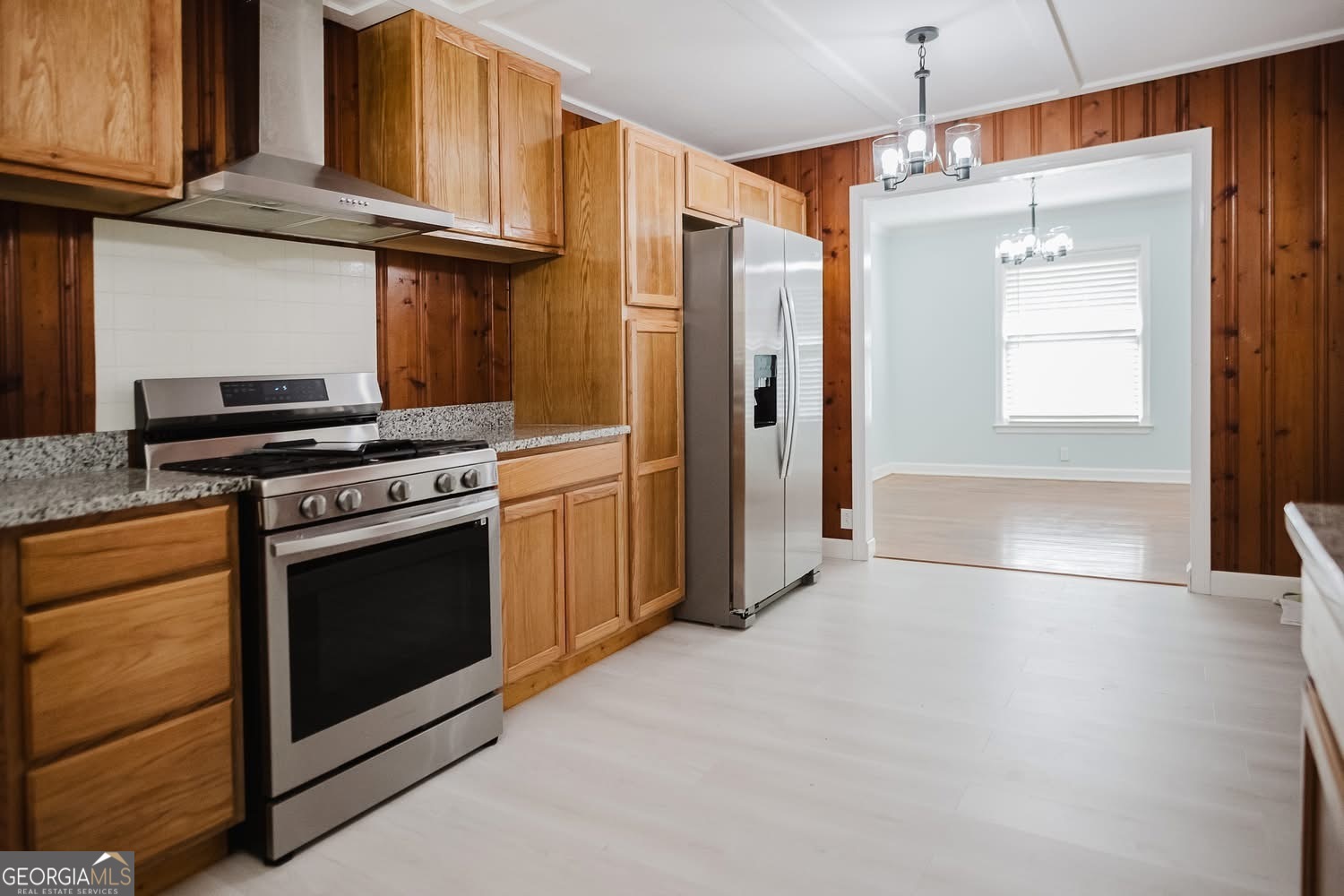 348 School Road Hampton, GA 30228 - Photo 13 of 46 a kitchen with stainless steel appliances granite countertop a refrigerator a stove and a sink with wooden cabinets
