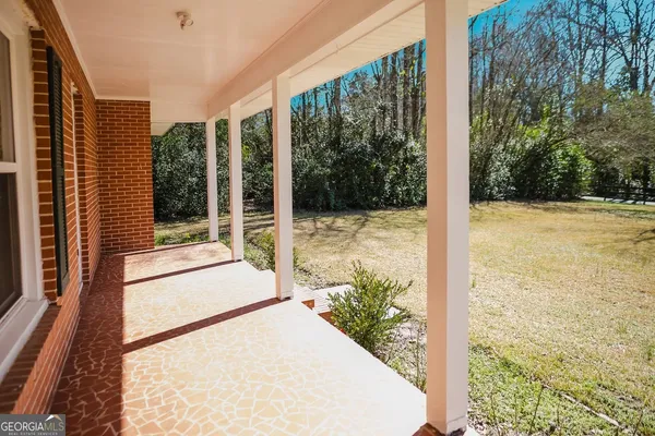 a view of a balcony with a floor to ceiling window and floor to ceiling window and wooden fence