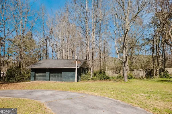 a front view of house with yard and trees