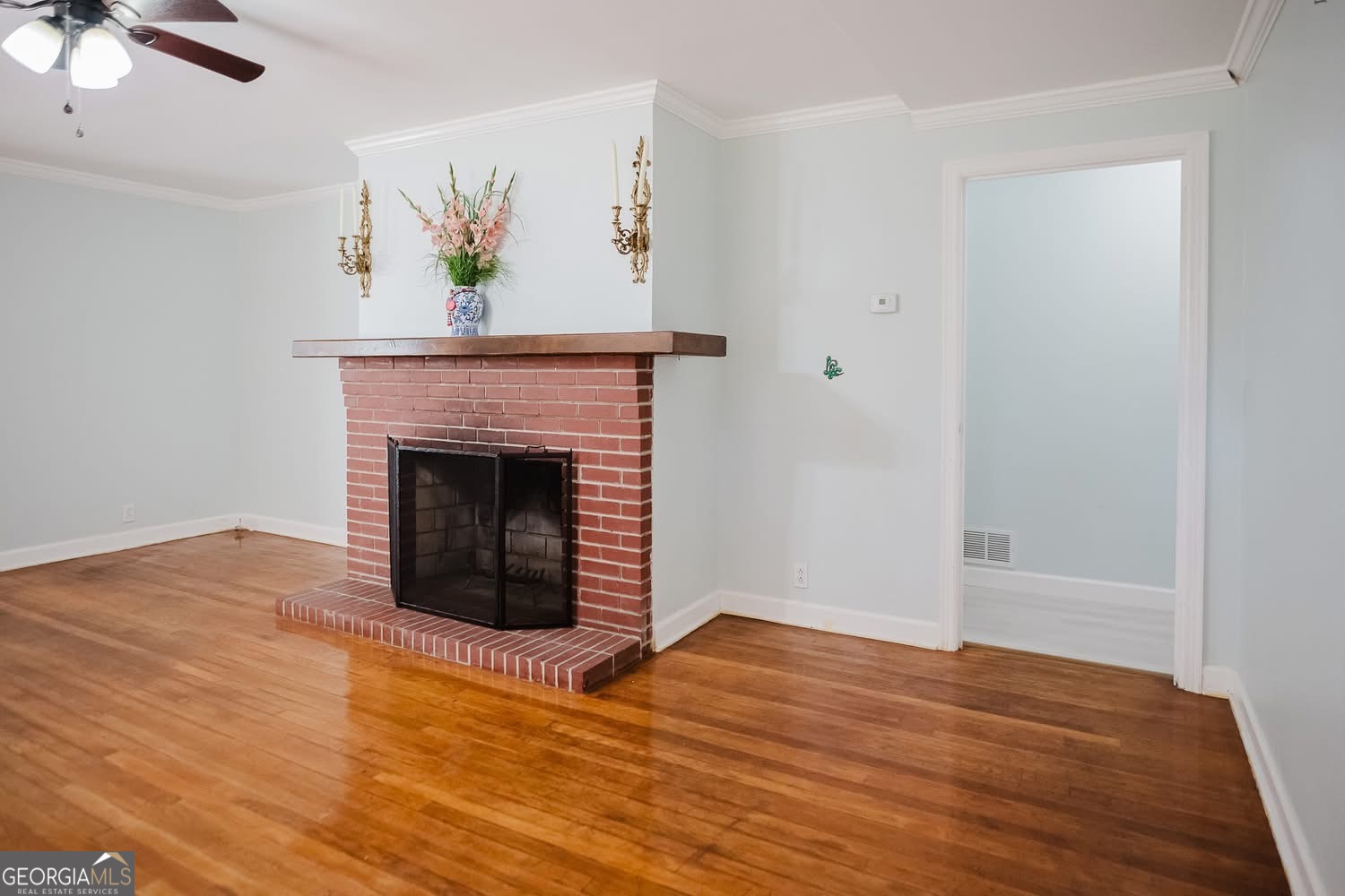 348 School Road Hampton, GA 30228 - Photo 6 of 46 a view of an empty room with wooden floor and a fireplace