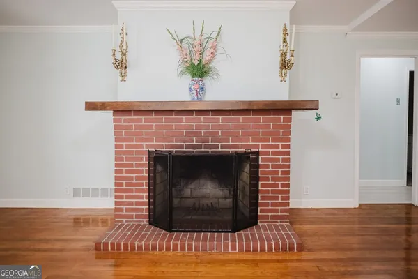 a living room with a fireplace and a wooden floor