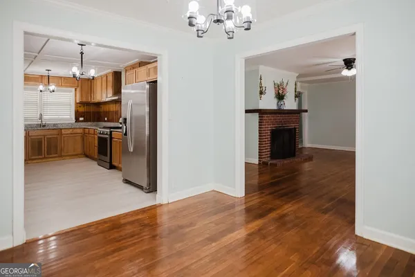 a view of kitchen with sink microwave and refrigerator
