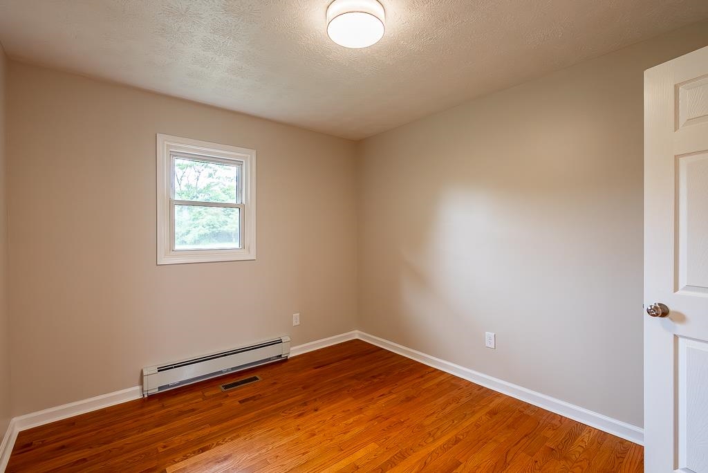 212 Esther's Lookout Shenandoah, VA 22849 - Photo 32 of 68 an empty room with wooden floor and windows