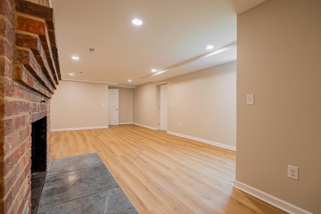 212 Esther's Lookout Shenandoah, VA 22849 - Photo 45 of 68 a view of an empty room with wooden floor and a fireplace