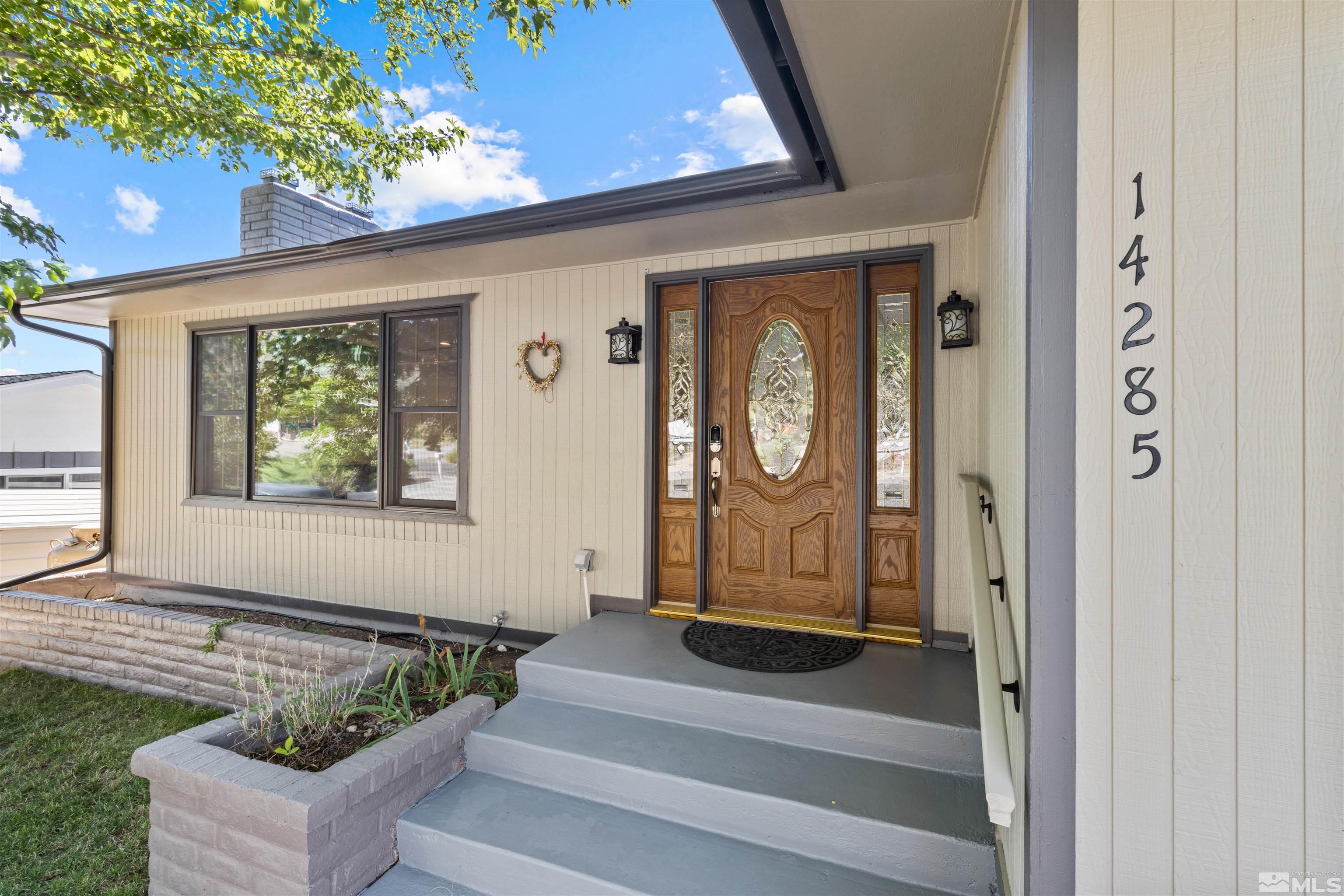 14285 Virginia Foothills Drive Reno, NV 89521 - Photo 1 of 39 a front view of a house with garden