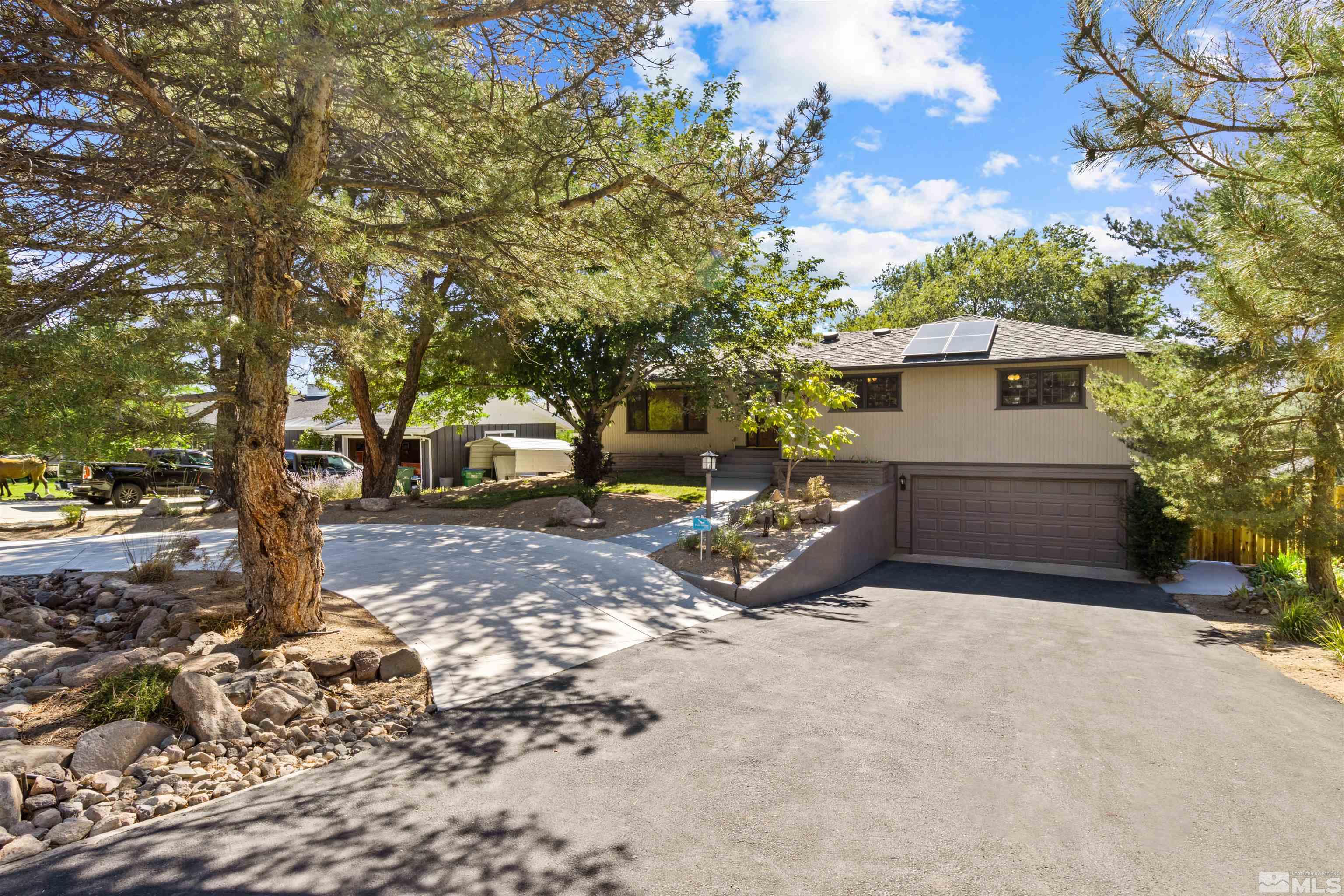14285 Virginia Foothills Drive Reno, NV 89521 - Photo 19 of 39 a view of a backyard with large trees