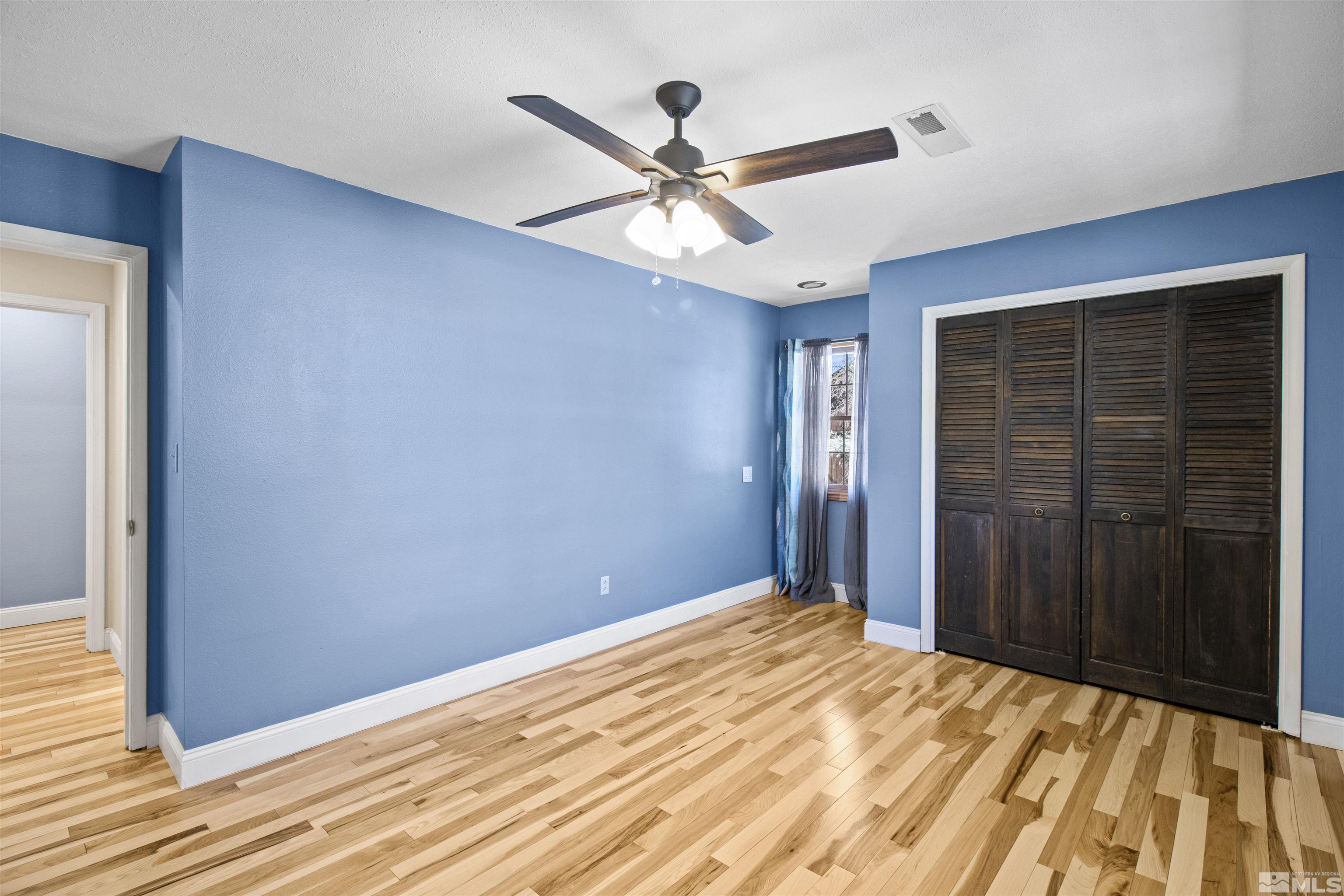 14285 Virginia Foothills Drive Reno, NV 89521 - Photo 20 of 39 a view of a livingroom with a ceiling fan and wooden floor