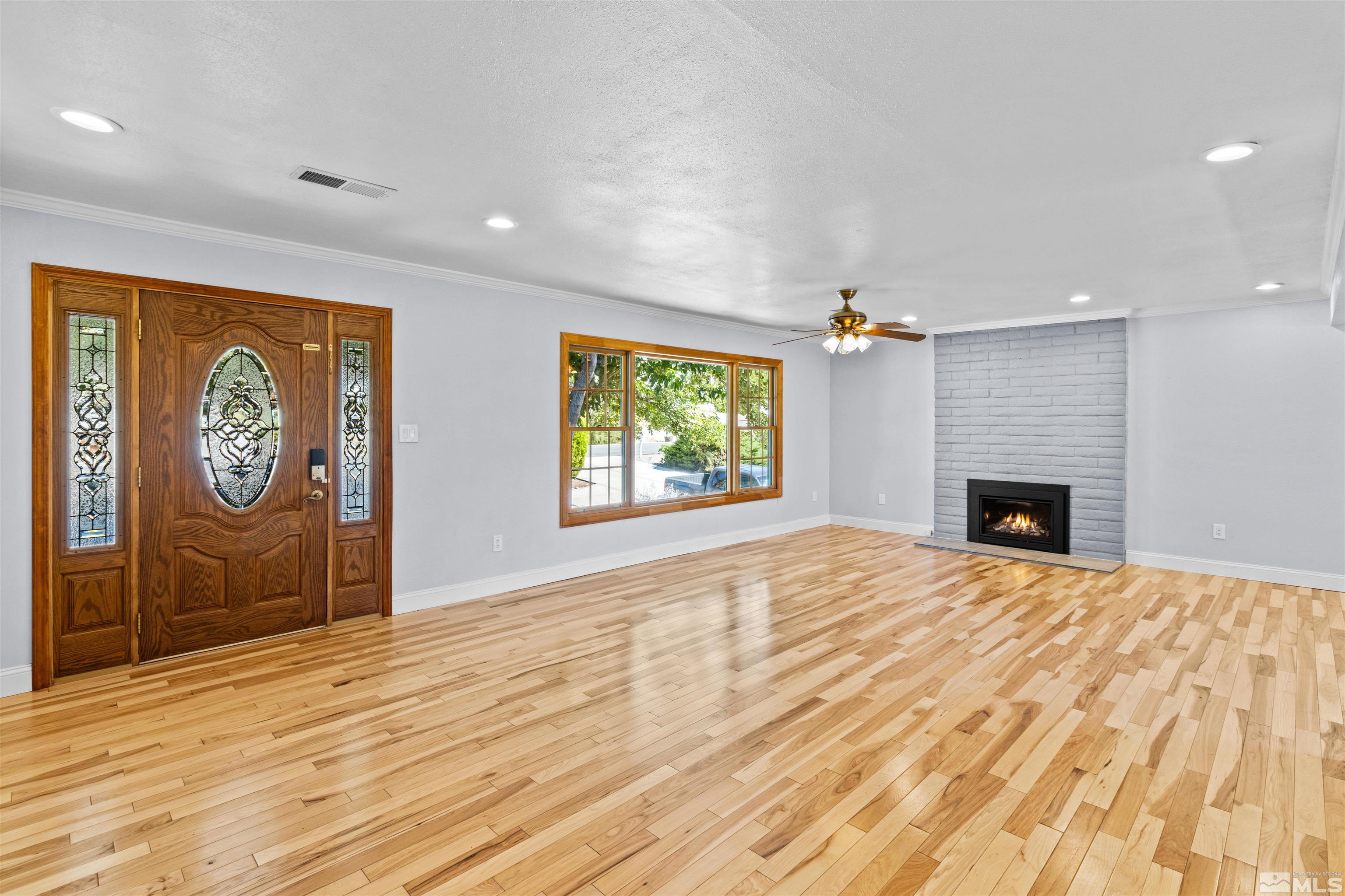 14285 Virginia Foothills Drive Reno, NV 89521 - Photo 2 of 39 a view of an empty room with a window and fireplace
