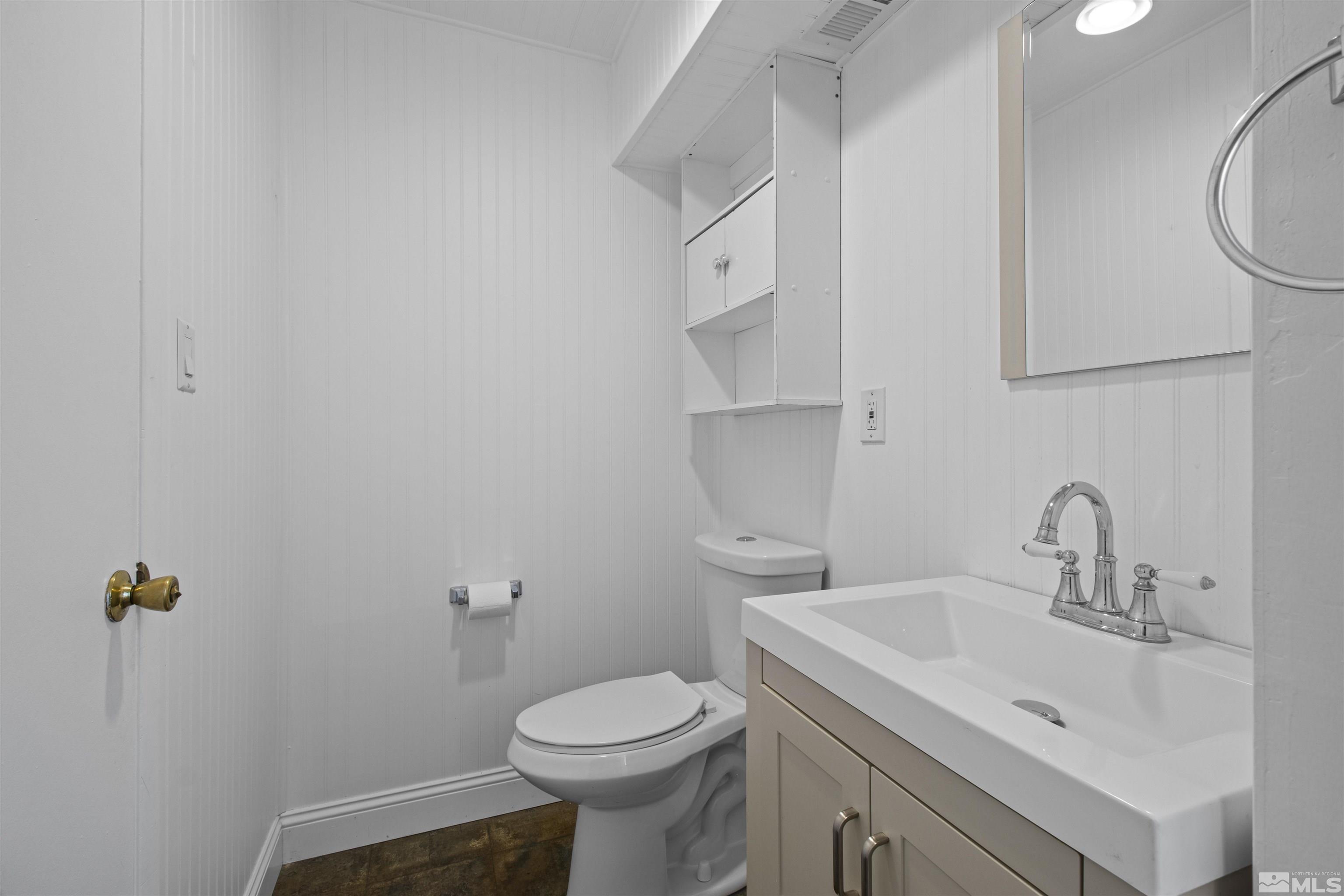 14285 Virginia Foothills Drive Reno, NV 89521 - Photo 32 of 39 a bathroom with a sink a toilet and a mirror
